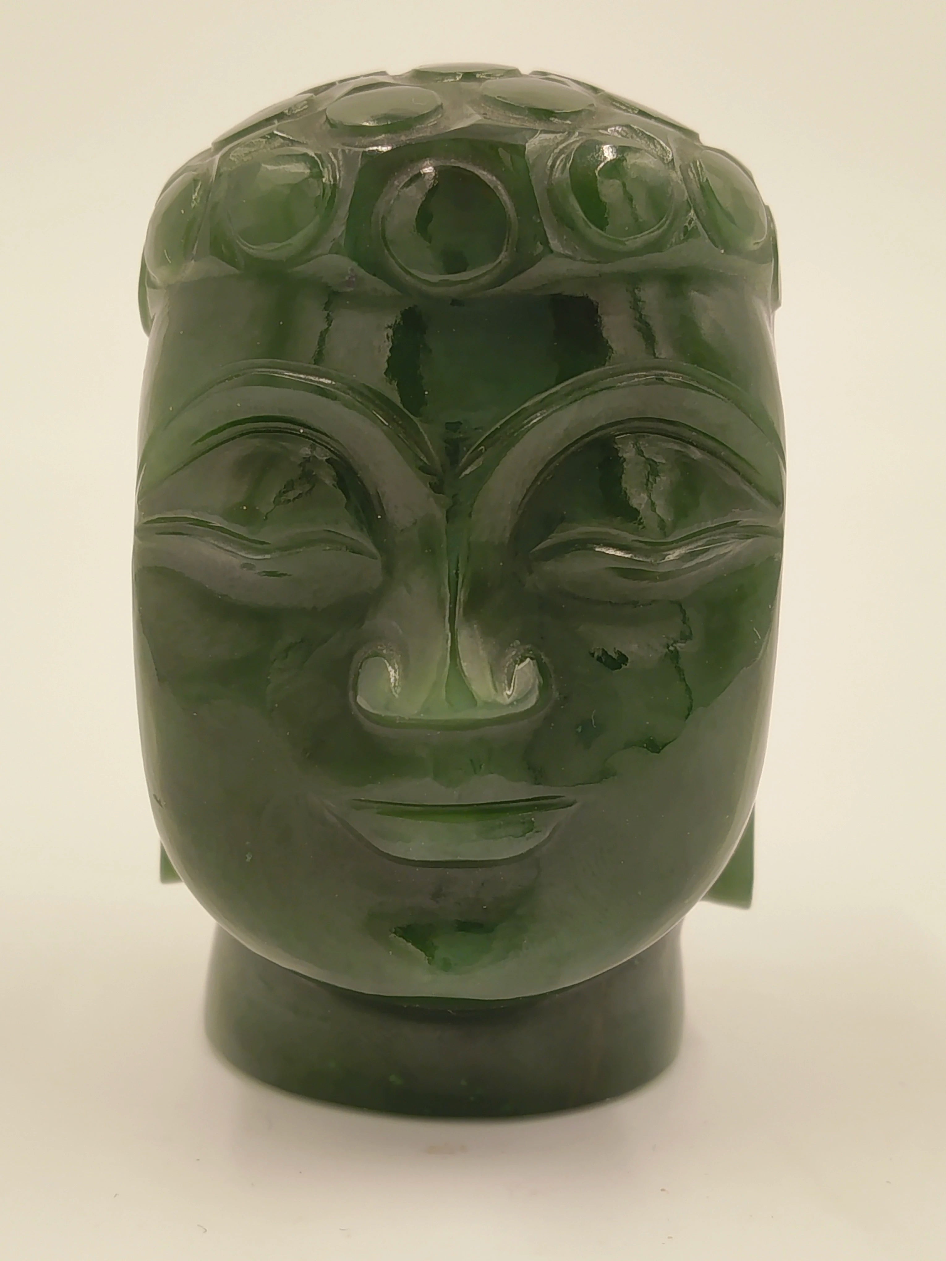 Small jade sculpture of Buddha head with smooth polished surface