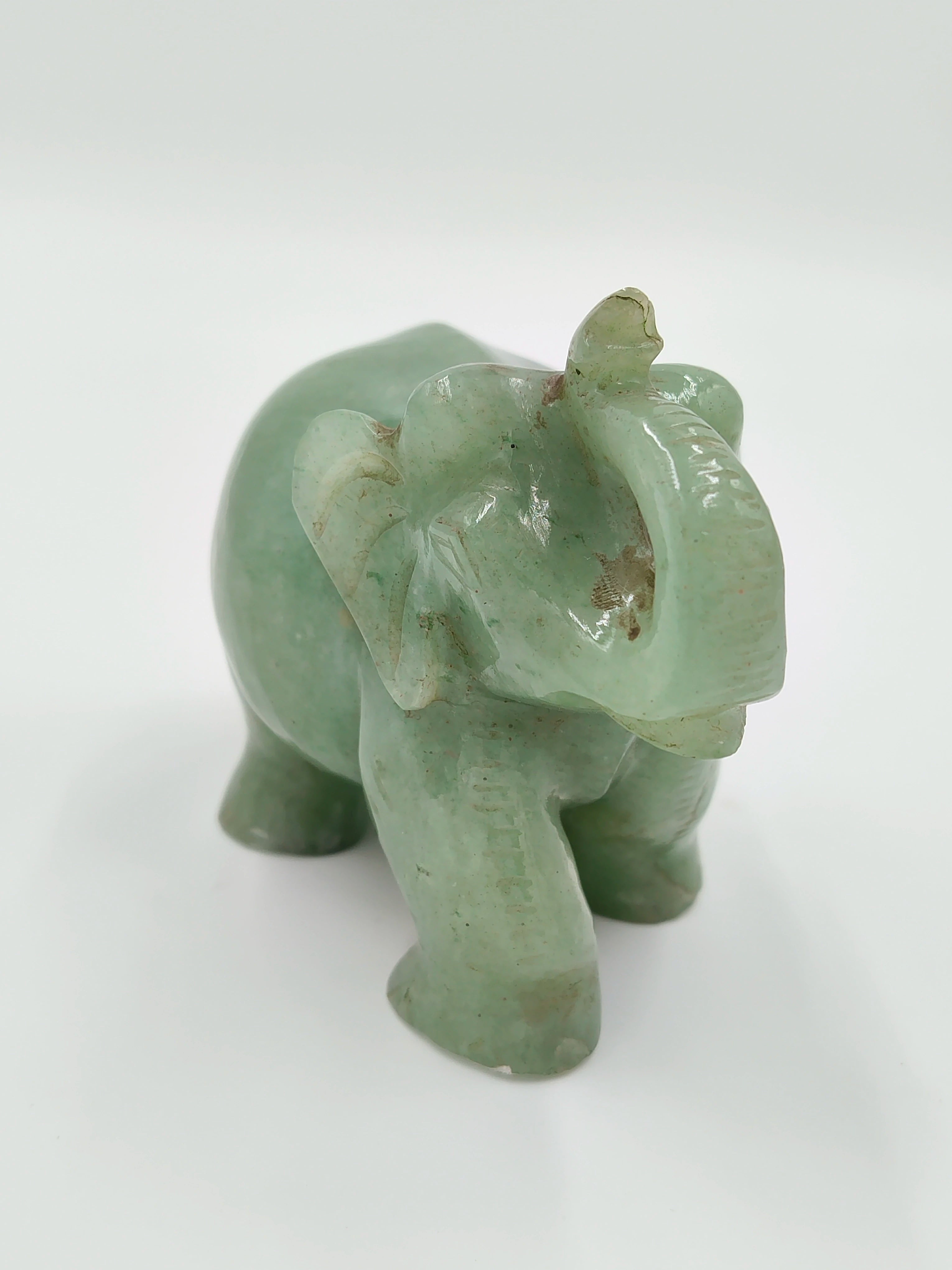 Small jade elephant sculpture with raised trunk and carved details