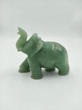 Small green jade elephant figurine with raised trunk side view