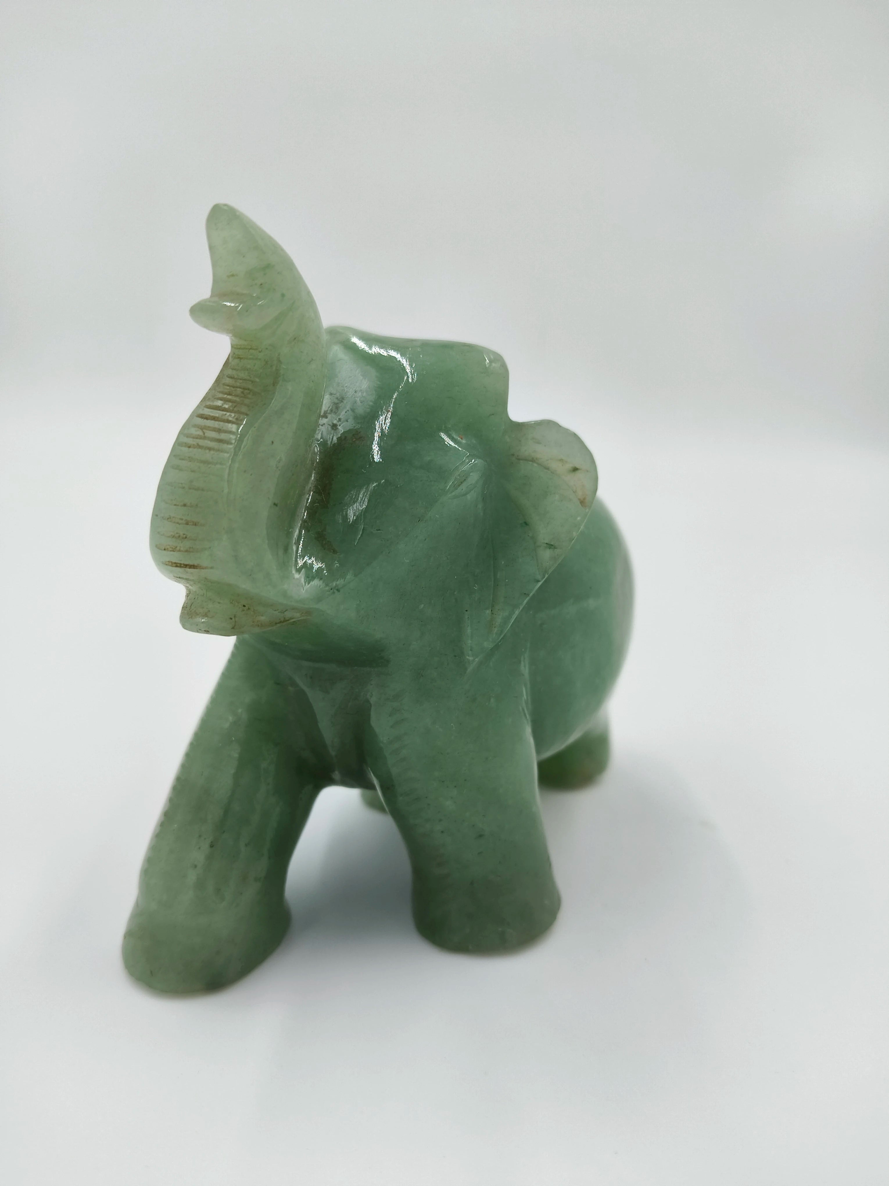 Small green jade elephant sculpture with raised trunk and carved detailing