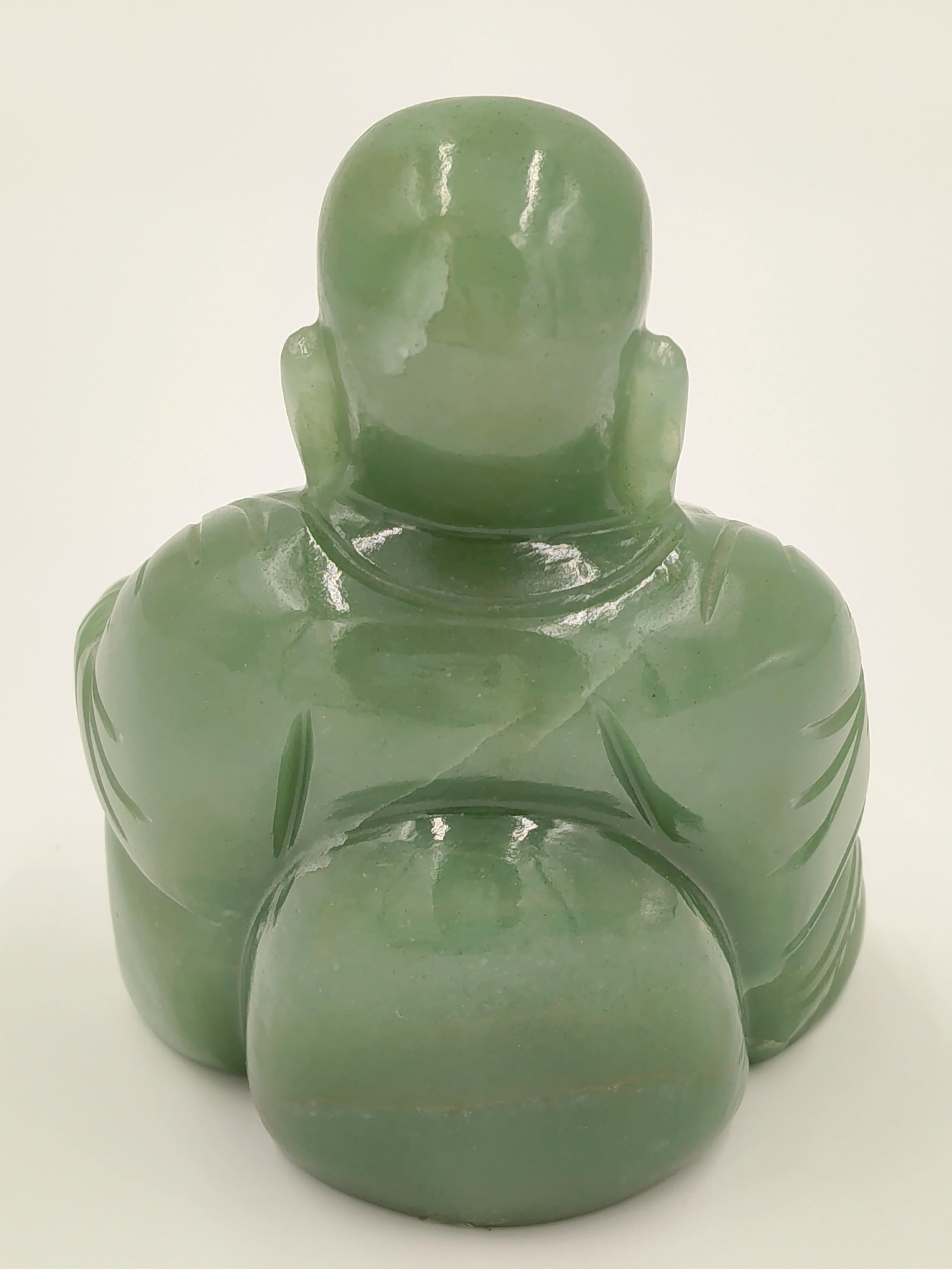 Back view of small jade Laughing Buddha idol sculpture