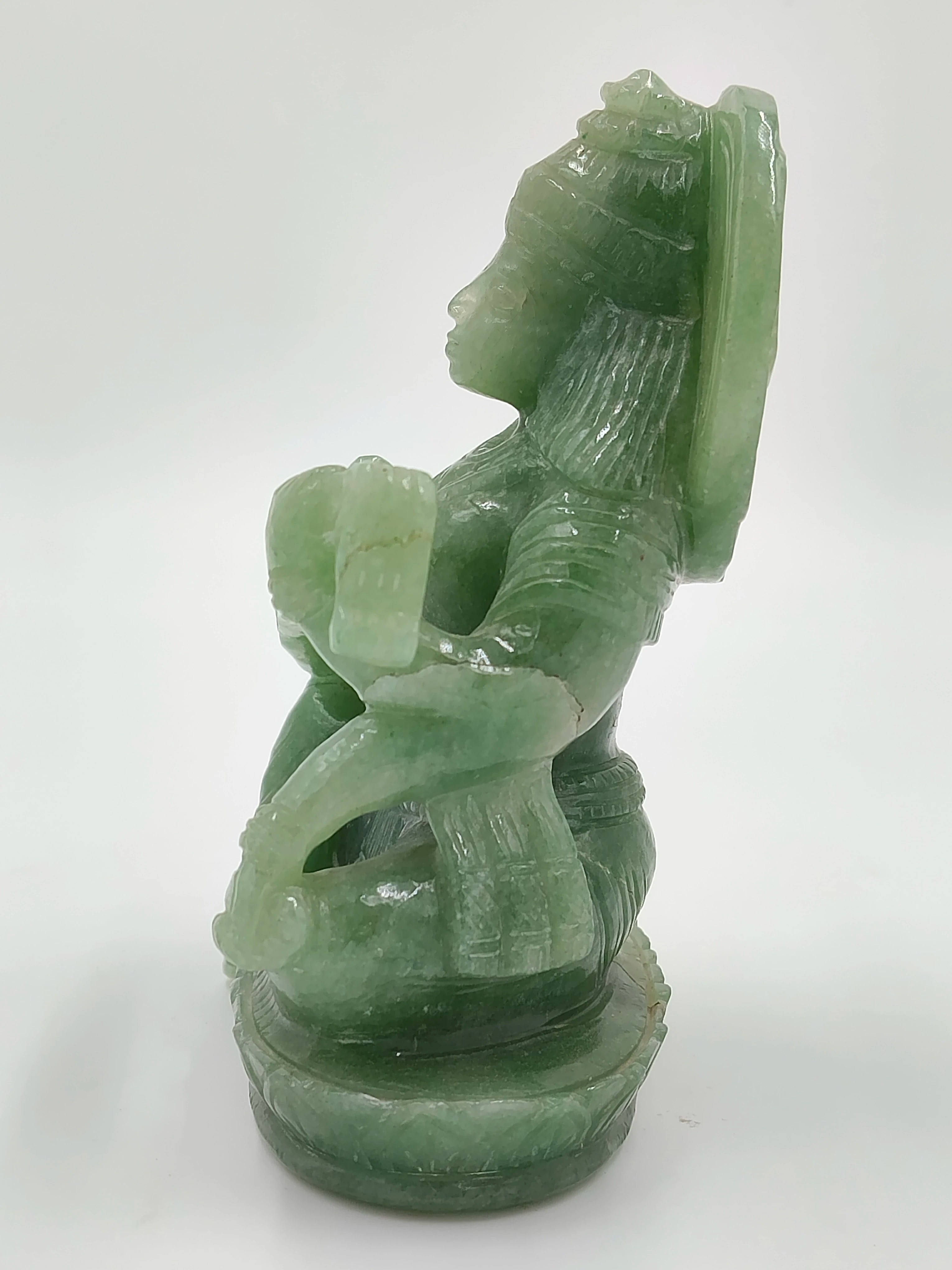 Green jade statue of seated Saraswathi goddess facing left