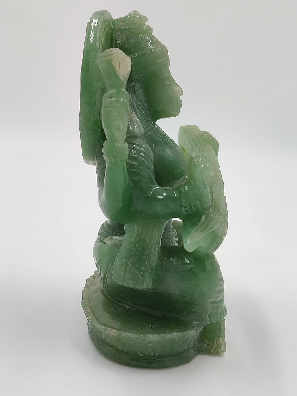 Green jade sculpture of Saraswathi deity in seated pose side view