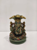 Large jade Ganesh statue with multi-painted details seated under a hood of snakes