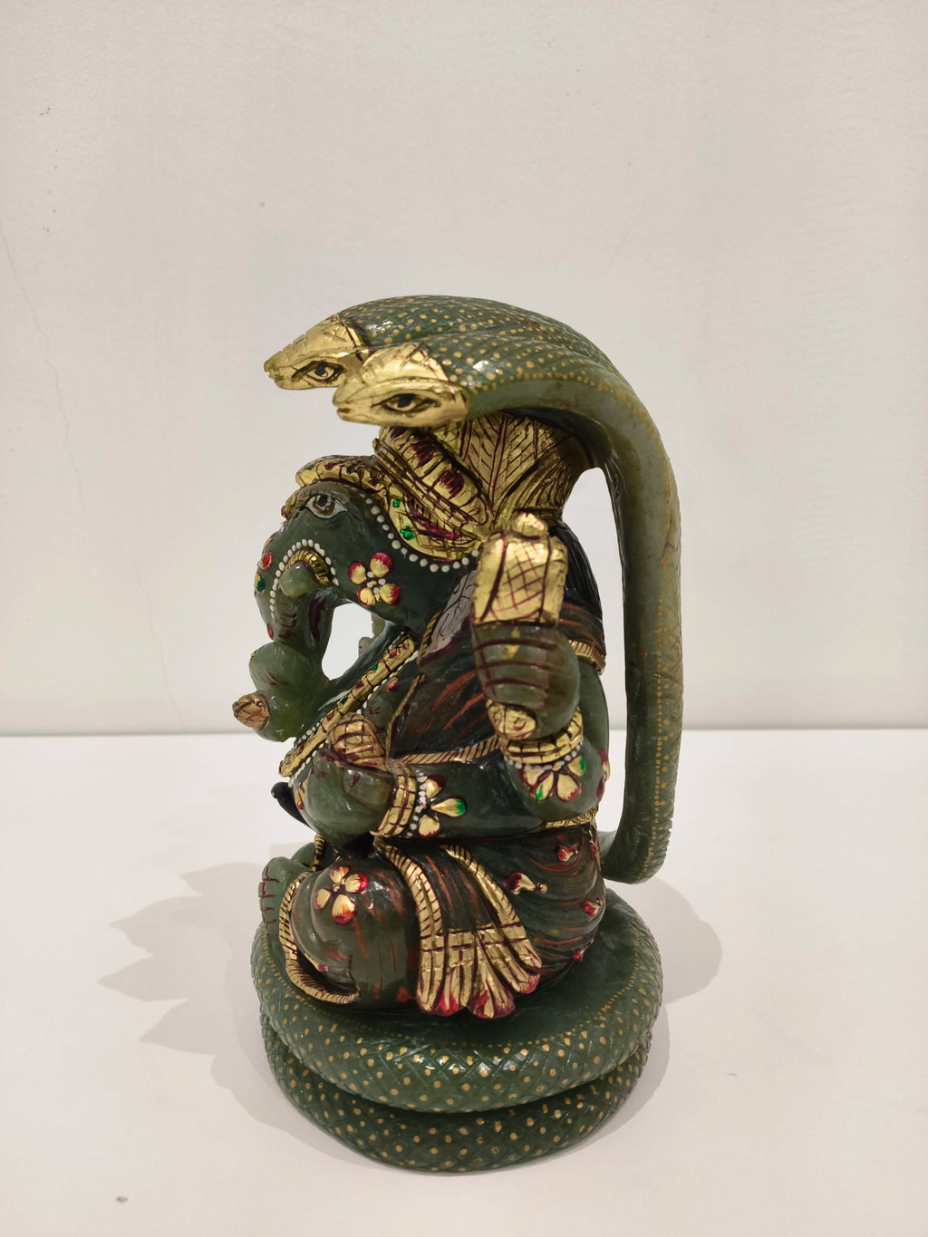 Large jade Ganesh statue with multi-paintings and three-headed cobra hood detail
