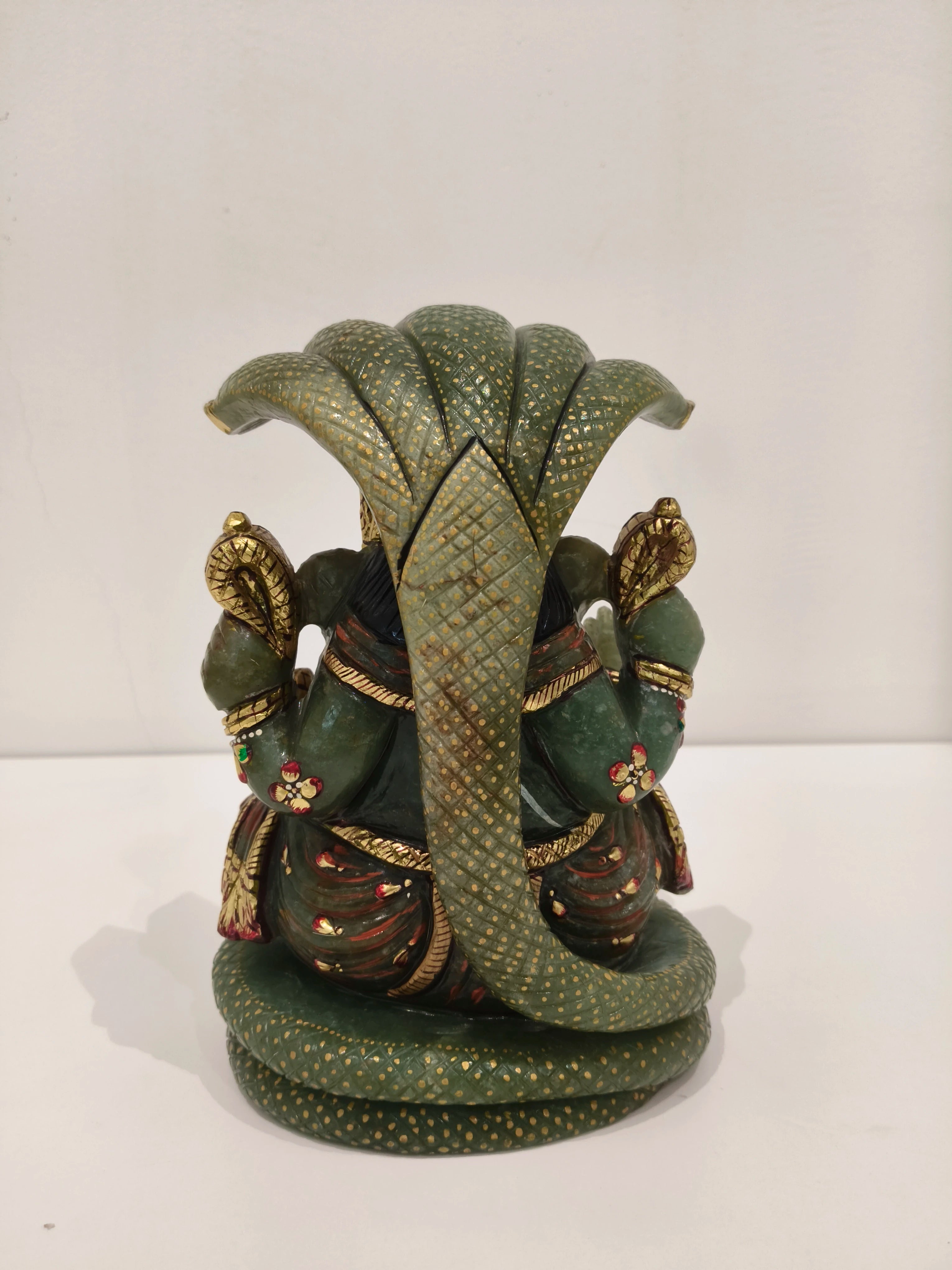 Back view of large jade Ganesh statue with gold and red multi-paint details