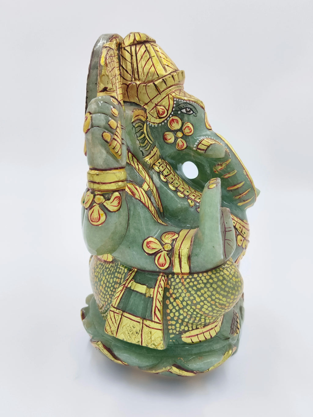 Side view of a jade Ganesh statue with intricate gold painting, 5.9 inches tall