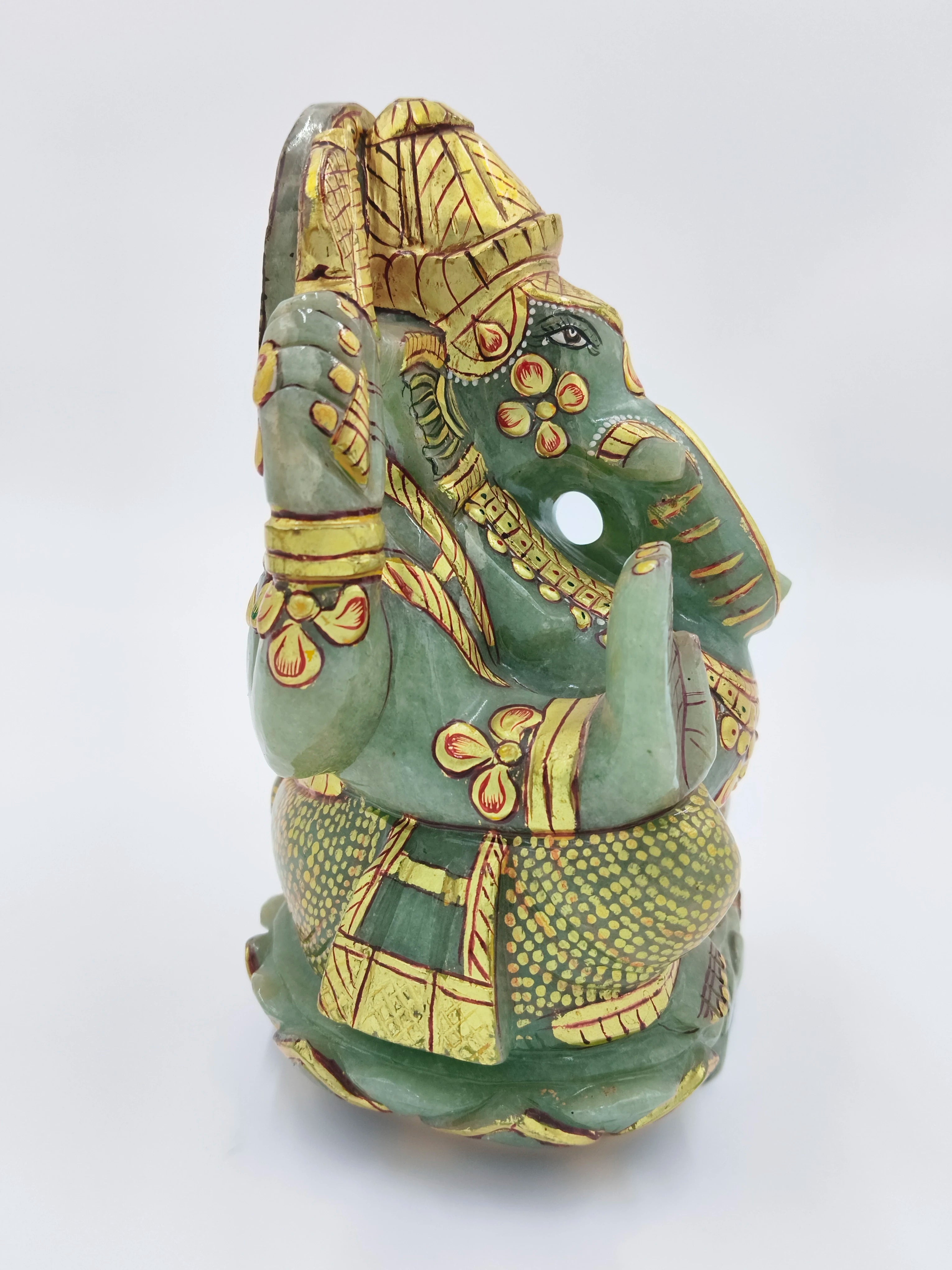 Side view of a jade Ganesh statue with intricate gold painting, 5.9 inches tall