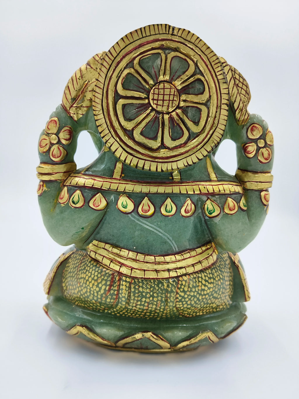 Back view of jade Ganesh sculpture with gold and red painting details