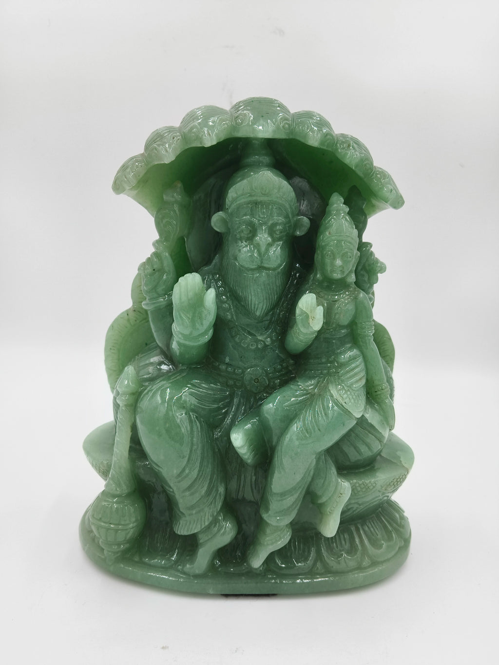 Green jade sculpture of Lakshmi Narasimha deity seated under a canopy