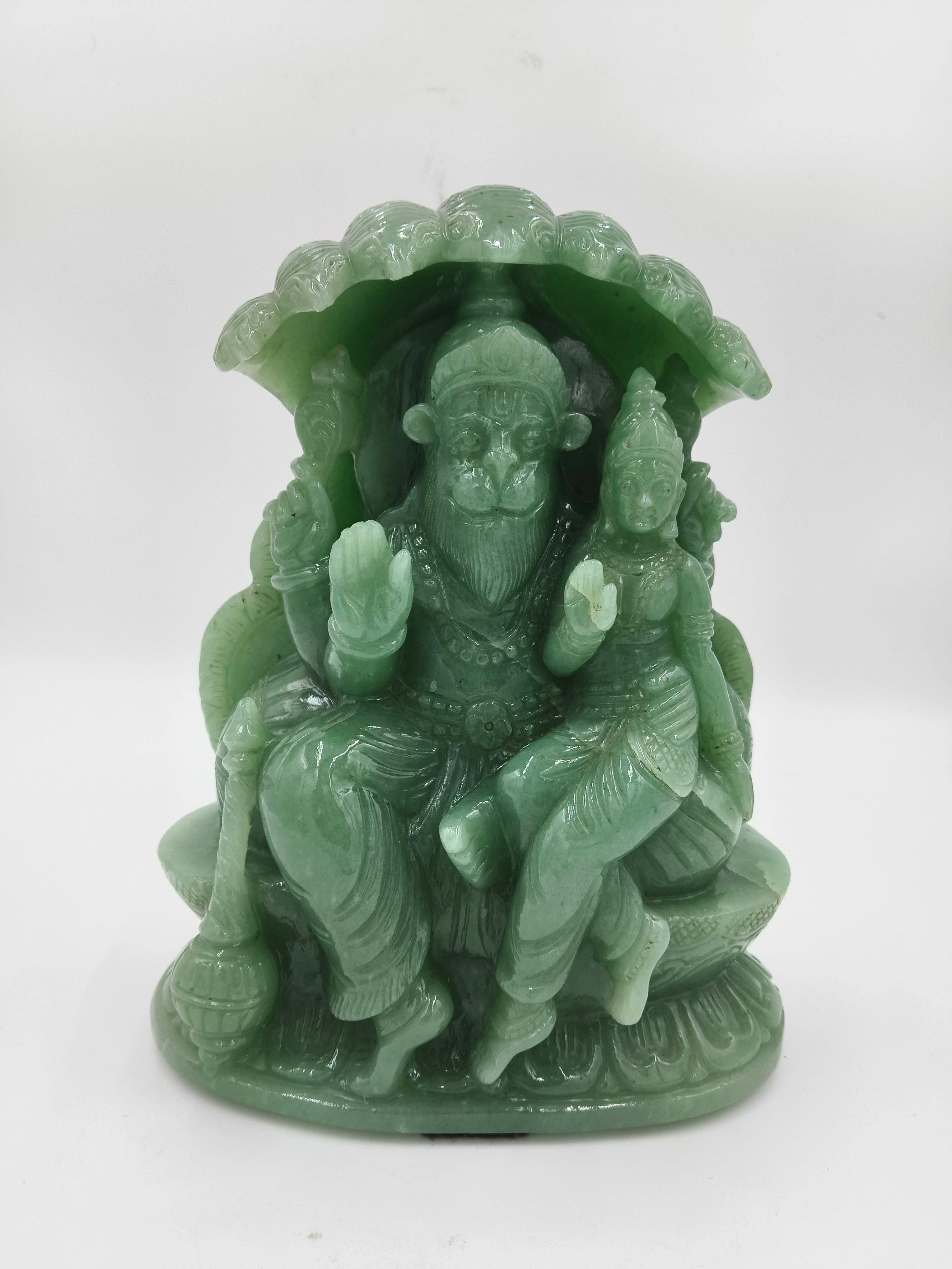 Green jade sculpture of Lakshmi Narasimha deity seated under a canopy