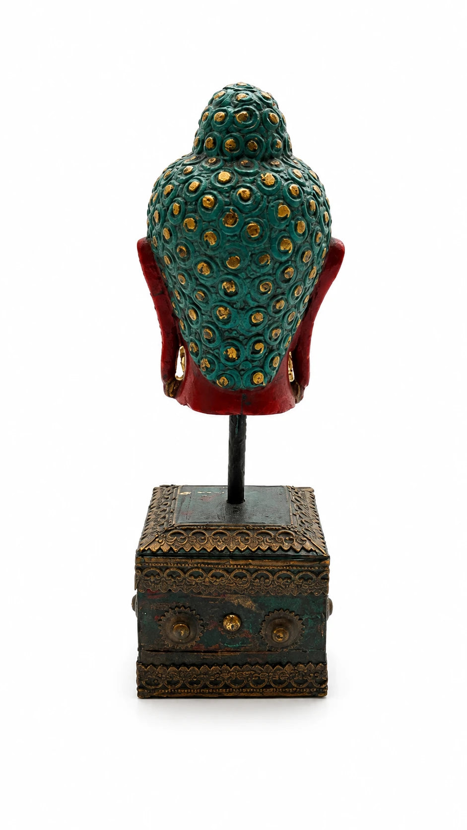Rear view of large stone Buddha head sculpture with decorative base