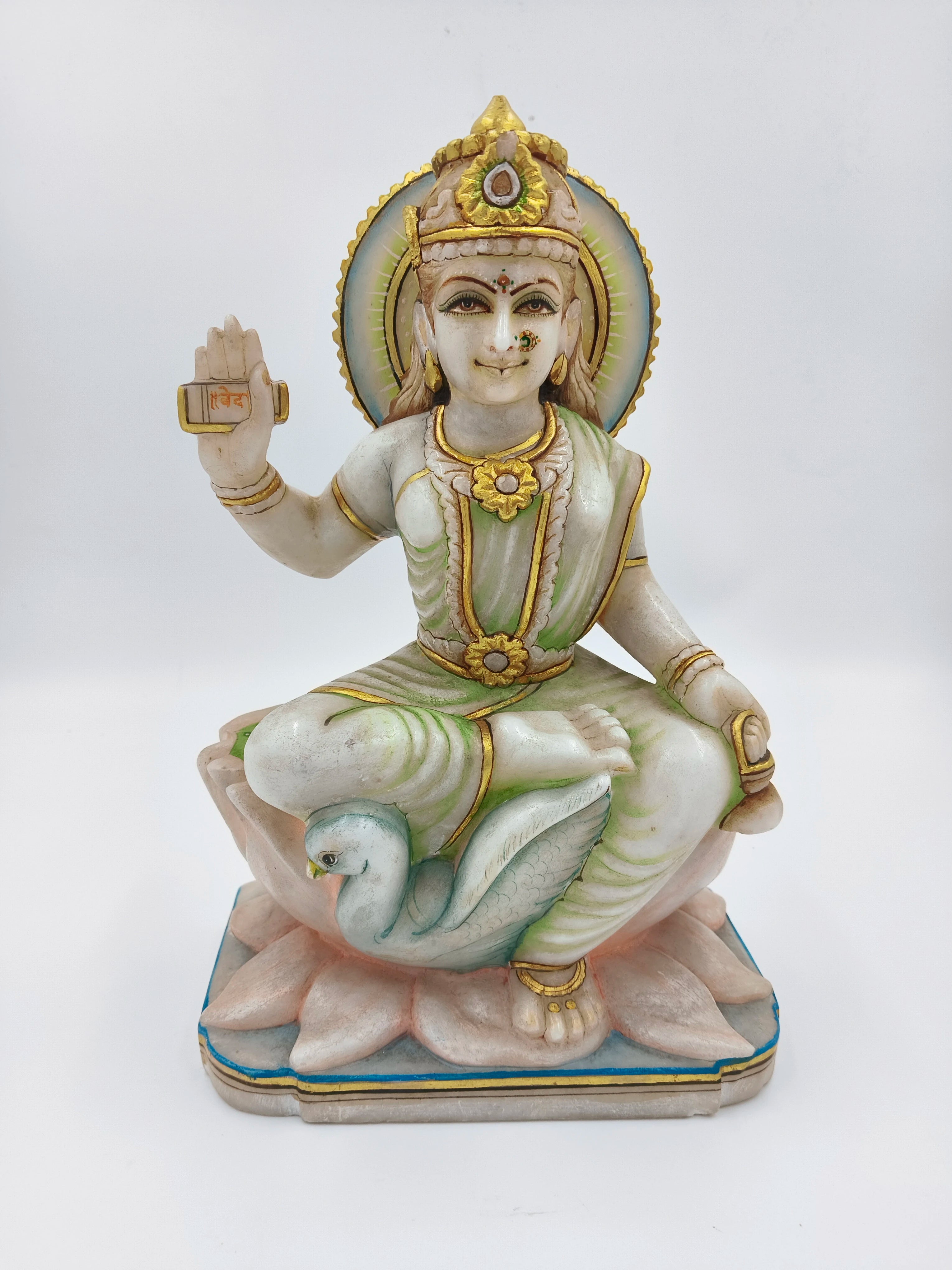 Marble sculpture of goddess Gayatri seated on a lotus with a swan