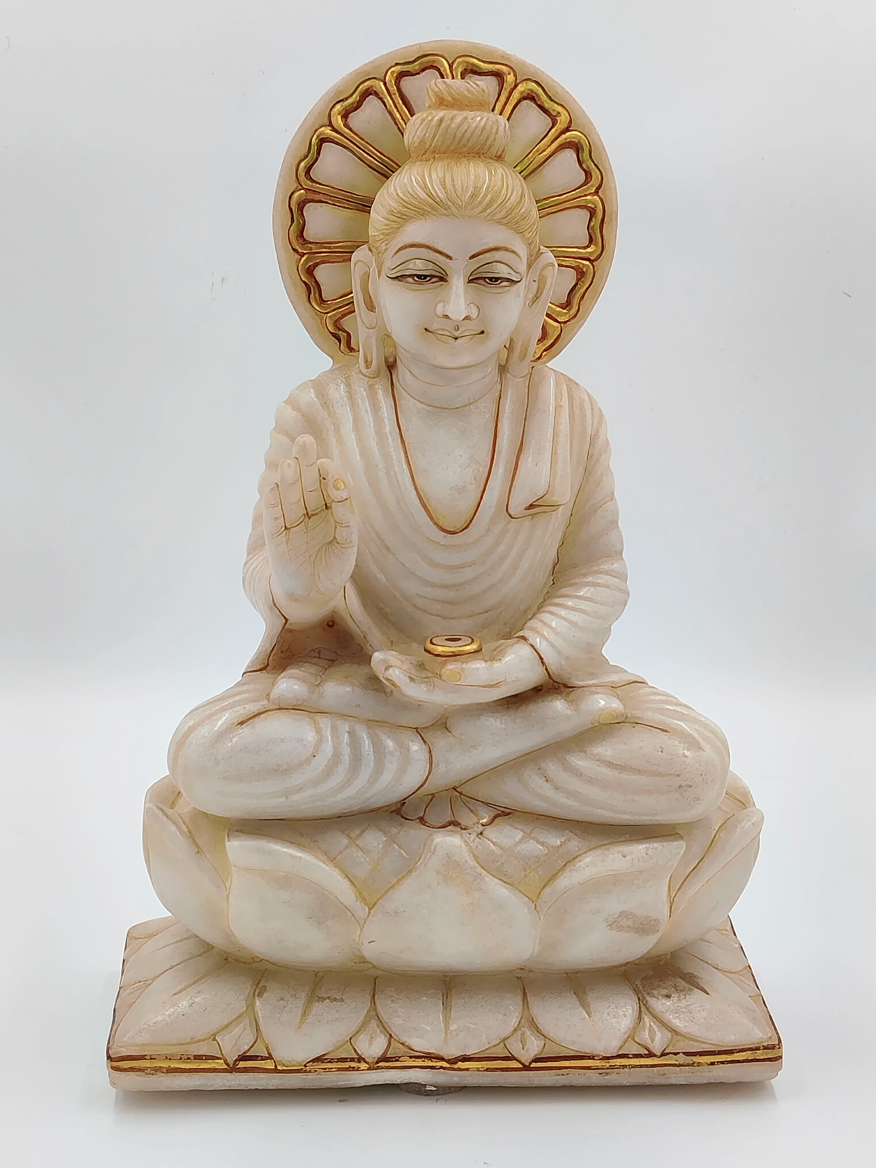 White marble Buddha statue sitting on lotus with gold accents front view