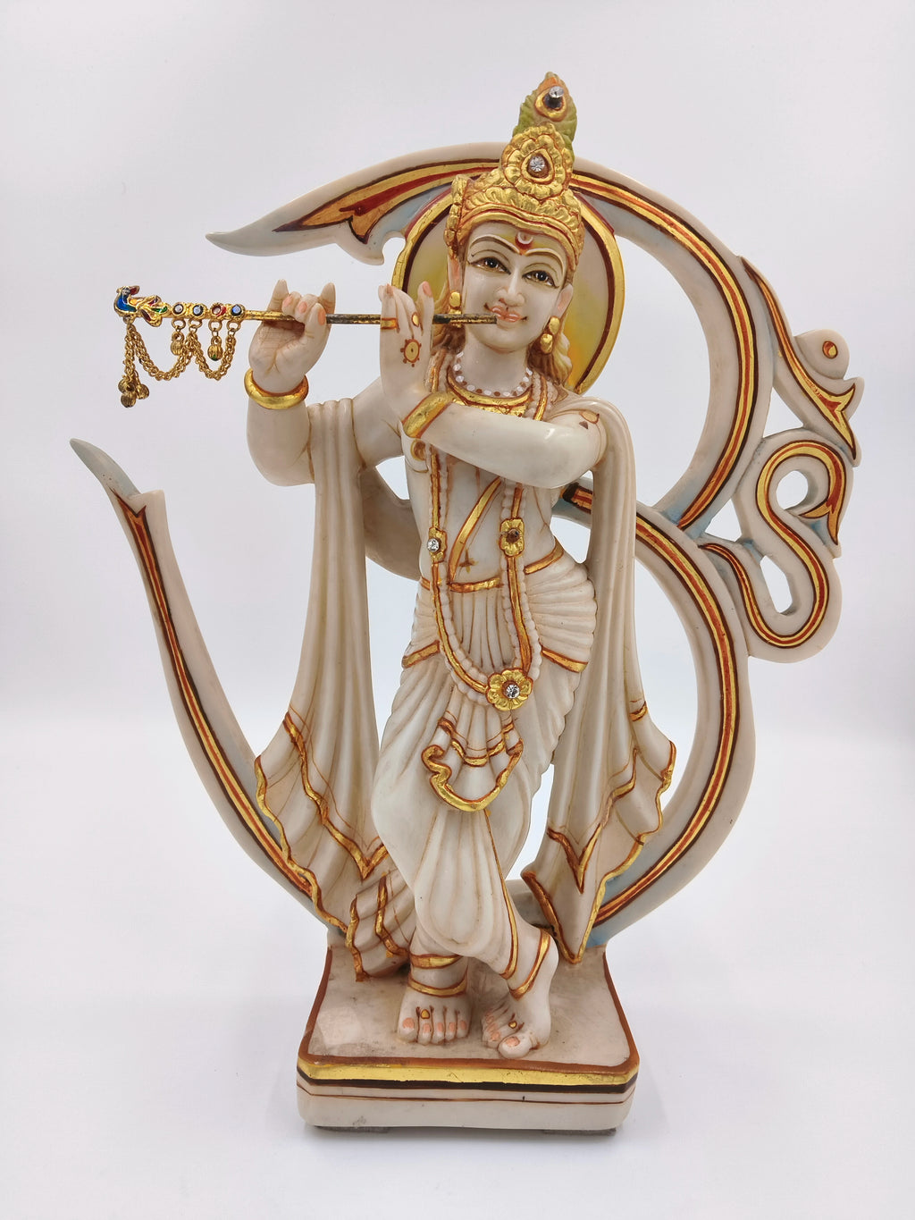 Marble dust Krishna sculpture playing flute with Aum symbol backdrop