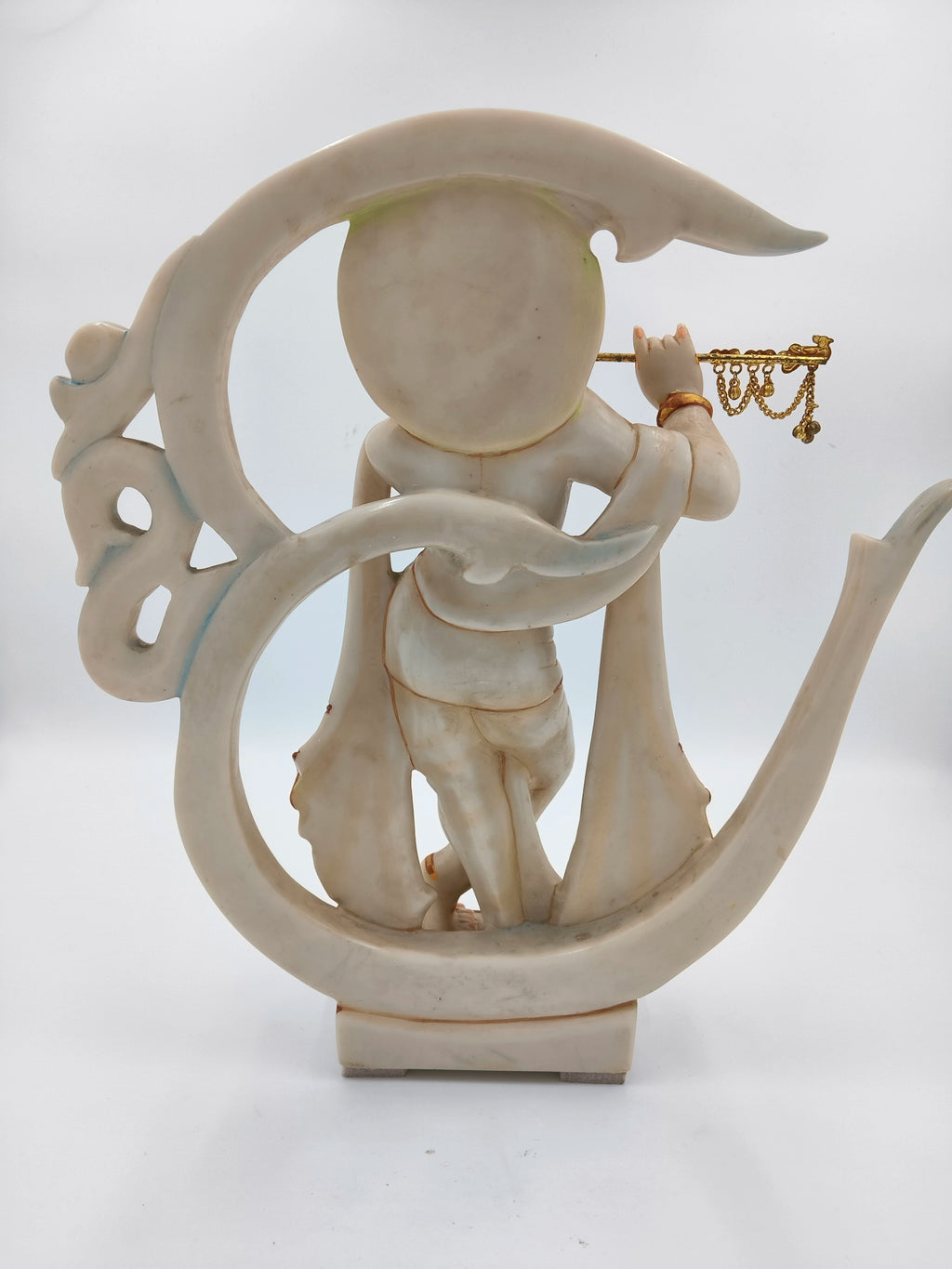 Back view of marble dust Krishna statue playing flute with Aum symbol frame