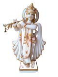 White marble sculpture of Krishna playing flute with gold and gem accents