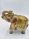 Side view of a 5.1 inch marble elephant figurine with gold and red decorative patterns