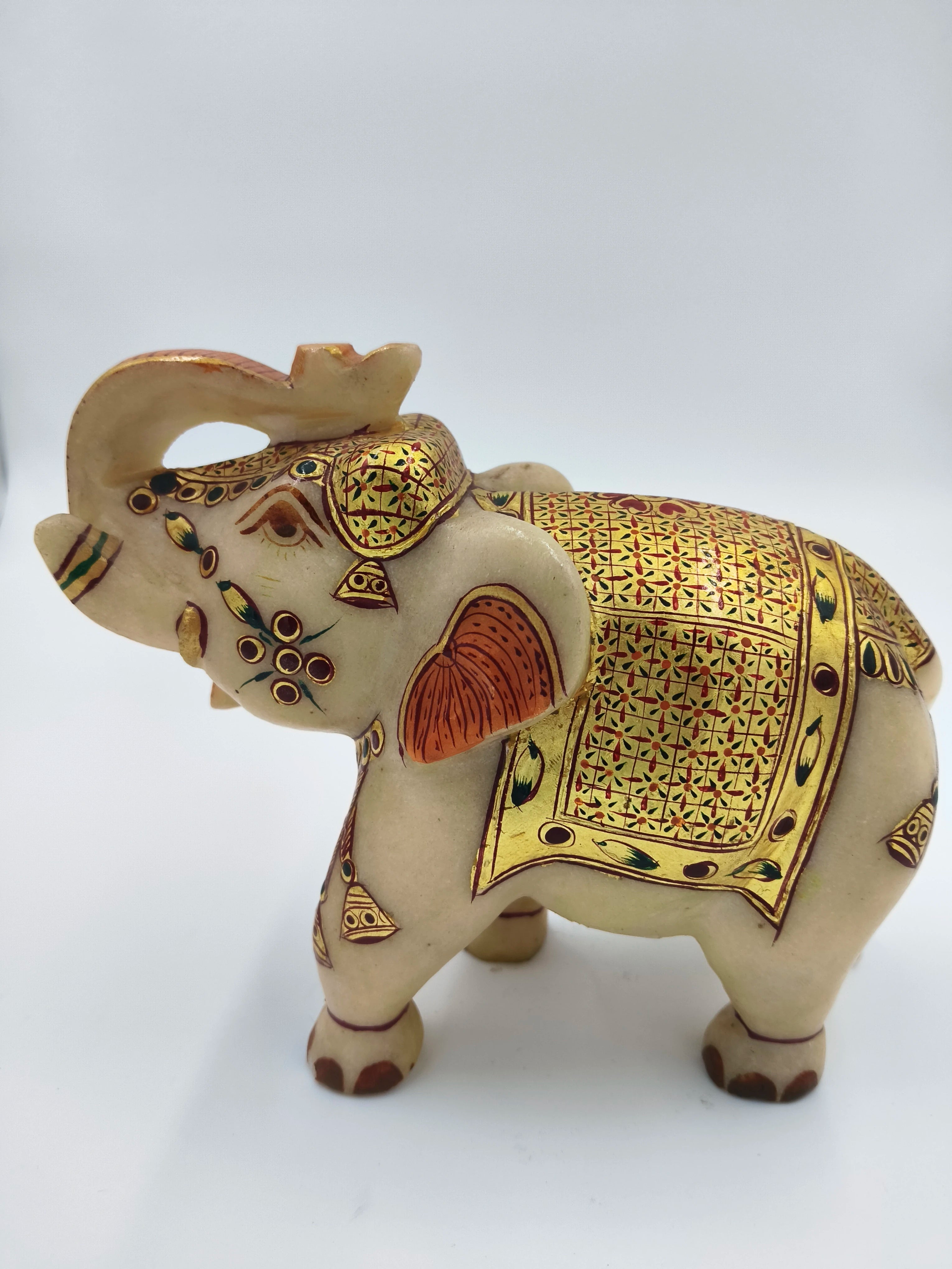 Side view of a 5.1 inch marble elephant figurine with gold and red decorative patterns