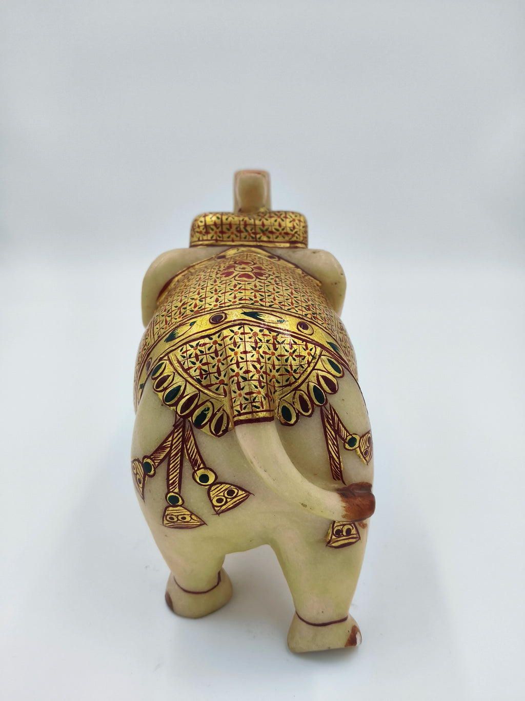 Back view of a 5.1 inch marble elephant figurine with intricate gold and red decoration