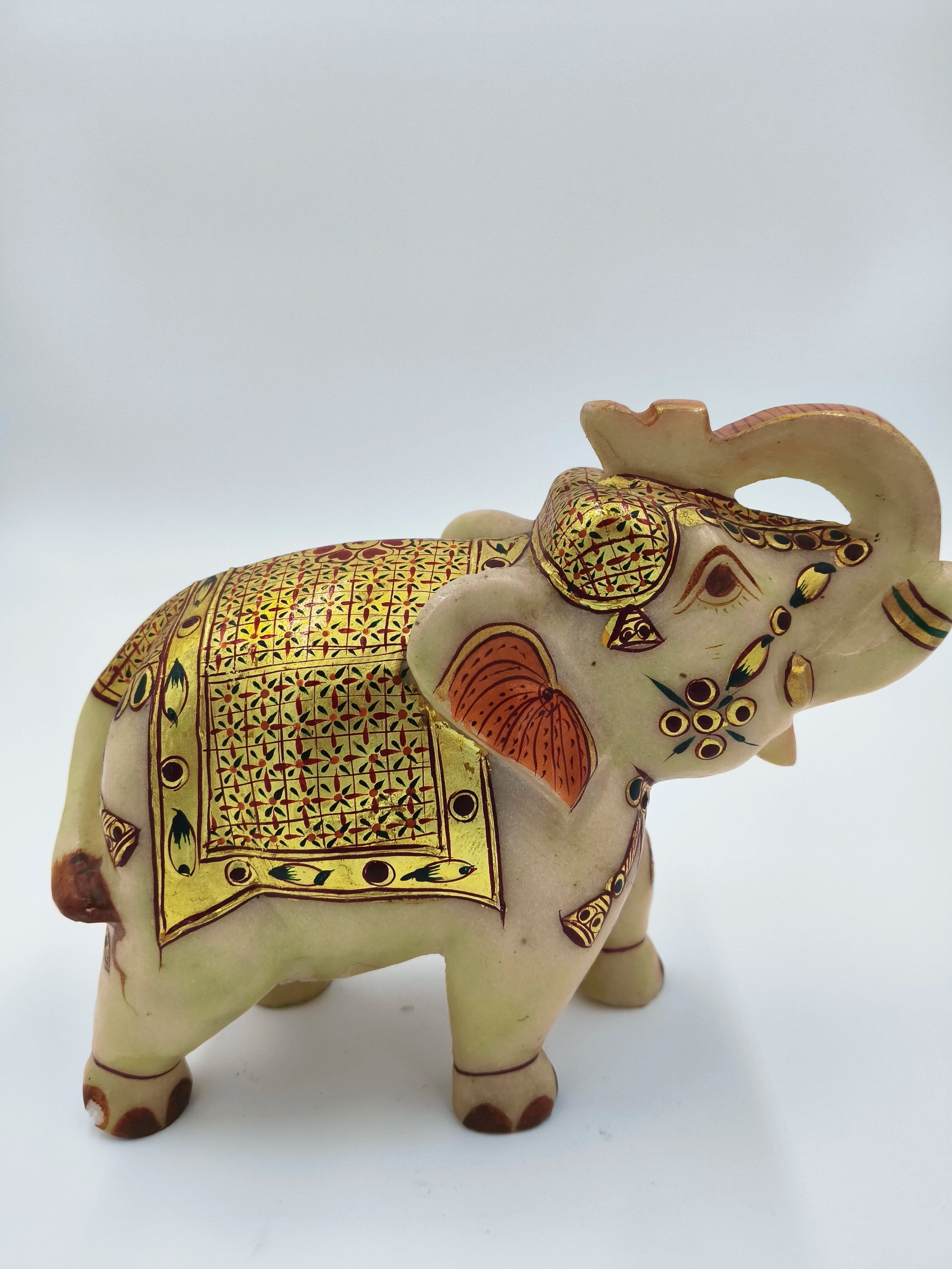 Hand-painted marble elephant sculpture with intricate gold and red designs