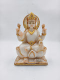White marble statue of Lakshmi goddess with gold and rhinestone accents, seated on lotus