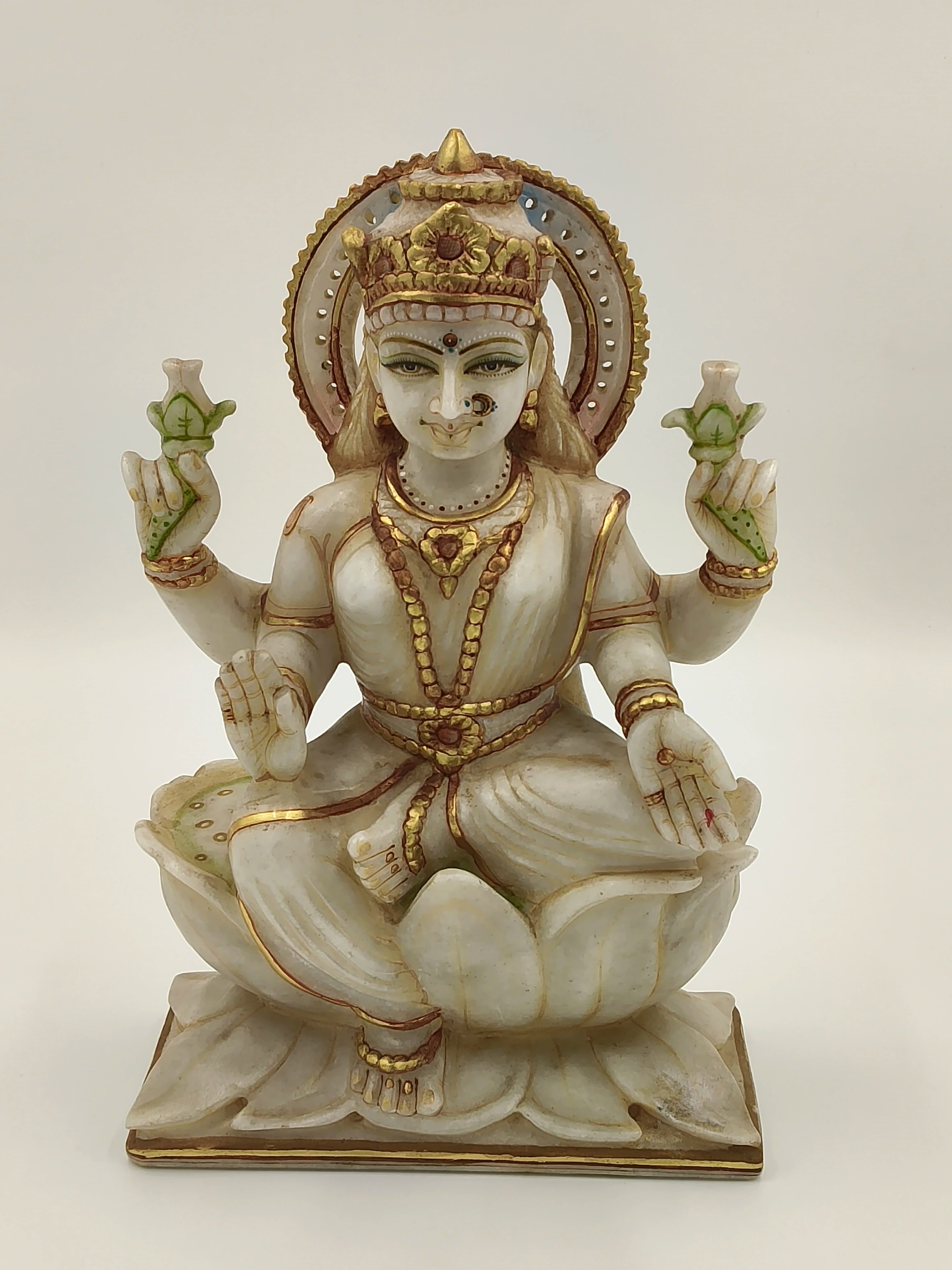 Front view of a 10.2 inch white marble Lakshmi statue seated on a lotus