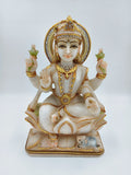 Marble sculpture of seated Lakshmi goddess with gold and gem accents