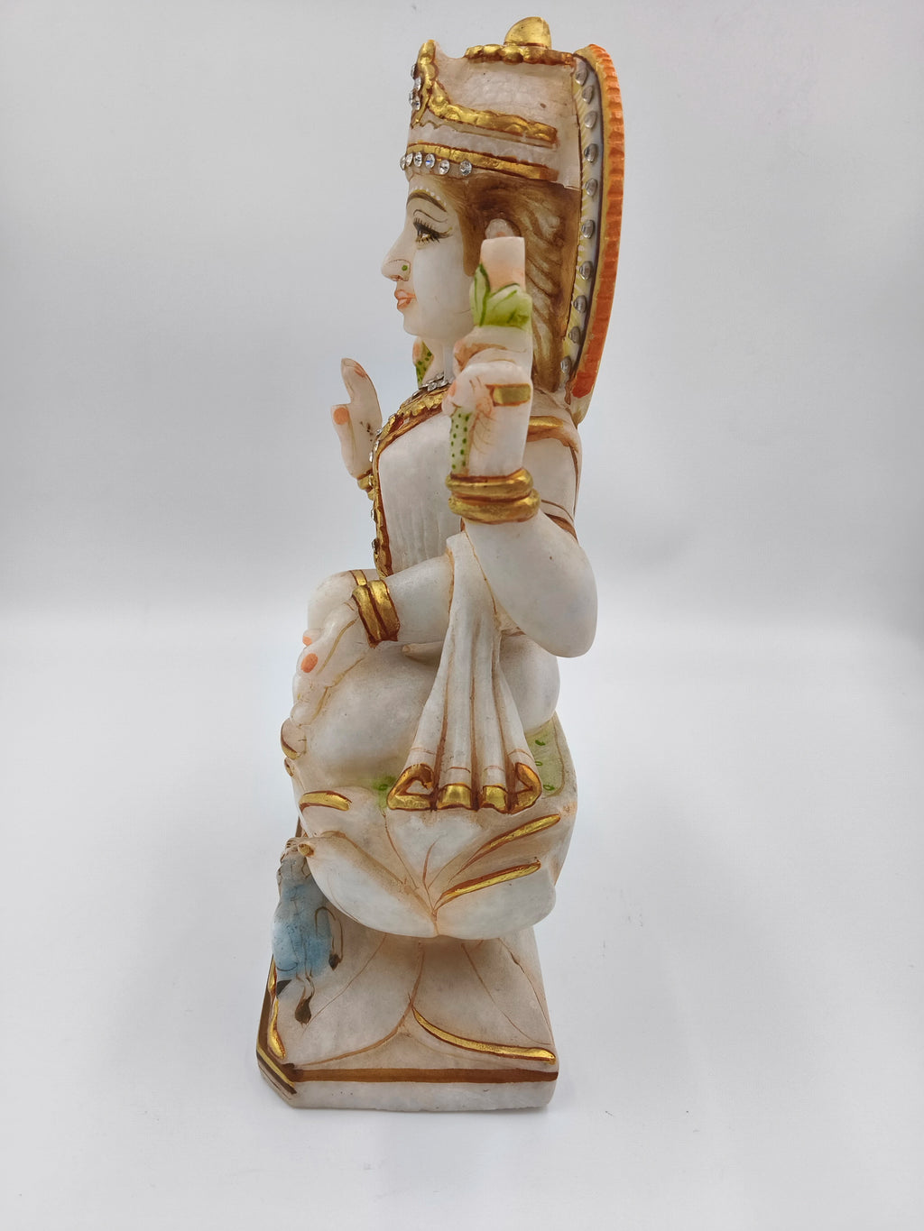 Side view of 11-inch marble Lakshmi statue with gold and colored accents