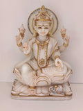 Marble statue of Goddess Lakshmi seated with four arms holding lotus flowers