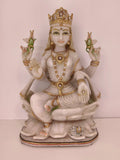 White marble statue of goddess Lakshmi seated on a lotus with gold accents