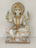 Large white marble Lakshmi statue with gold accents seated on lotus base