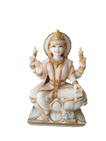 White marble Lakshmi statue with gold accents, seated on lotus base