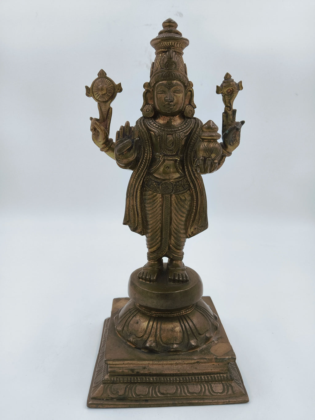 Front view of bronze Vishnu statue standing on decorated base