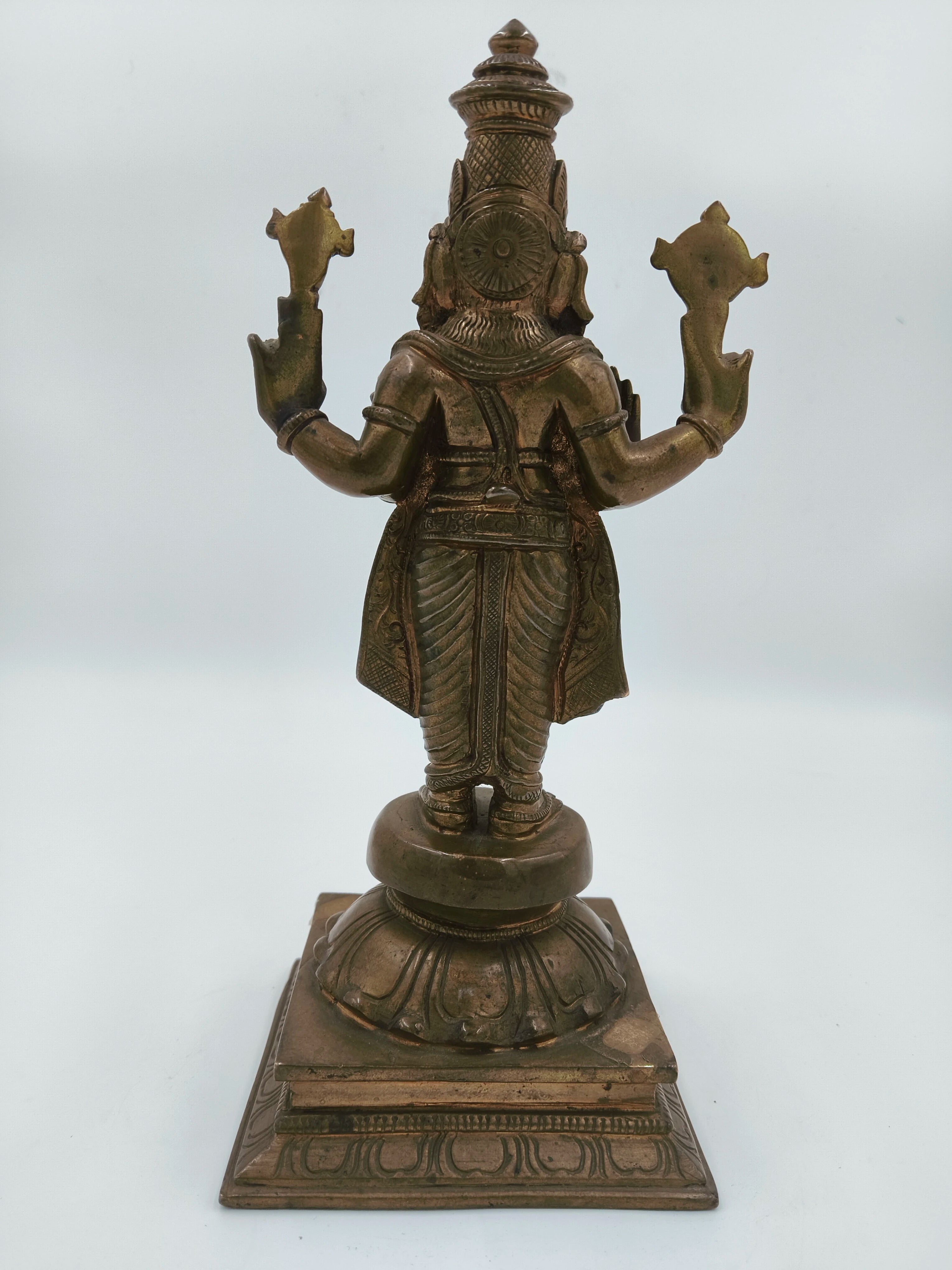 Rear view of large bronze Vishnu statue on pedestal base
