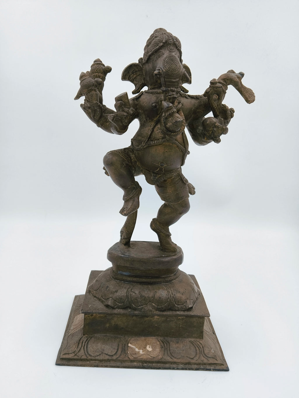 Large brass sculpture of dancing Ganesh on decorative base