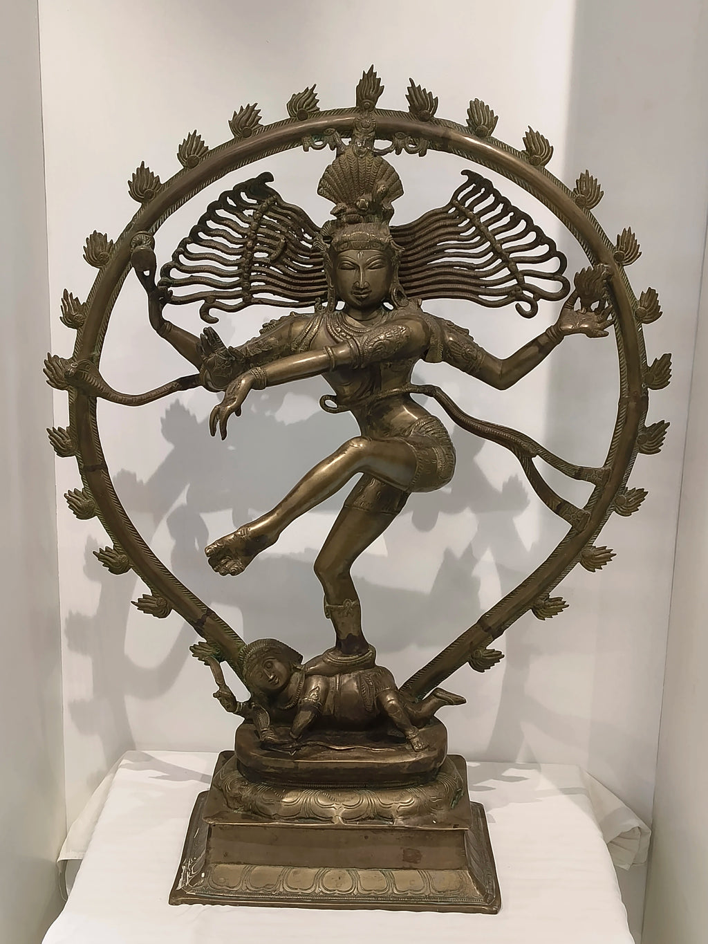 Large brass Nataraja statue depicting Shiva's cosmic dance on a decorative base