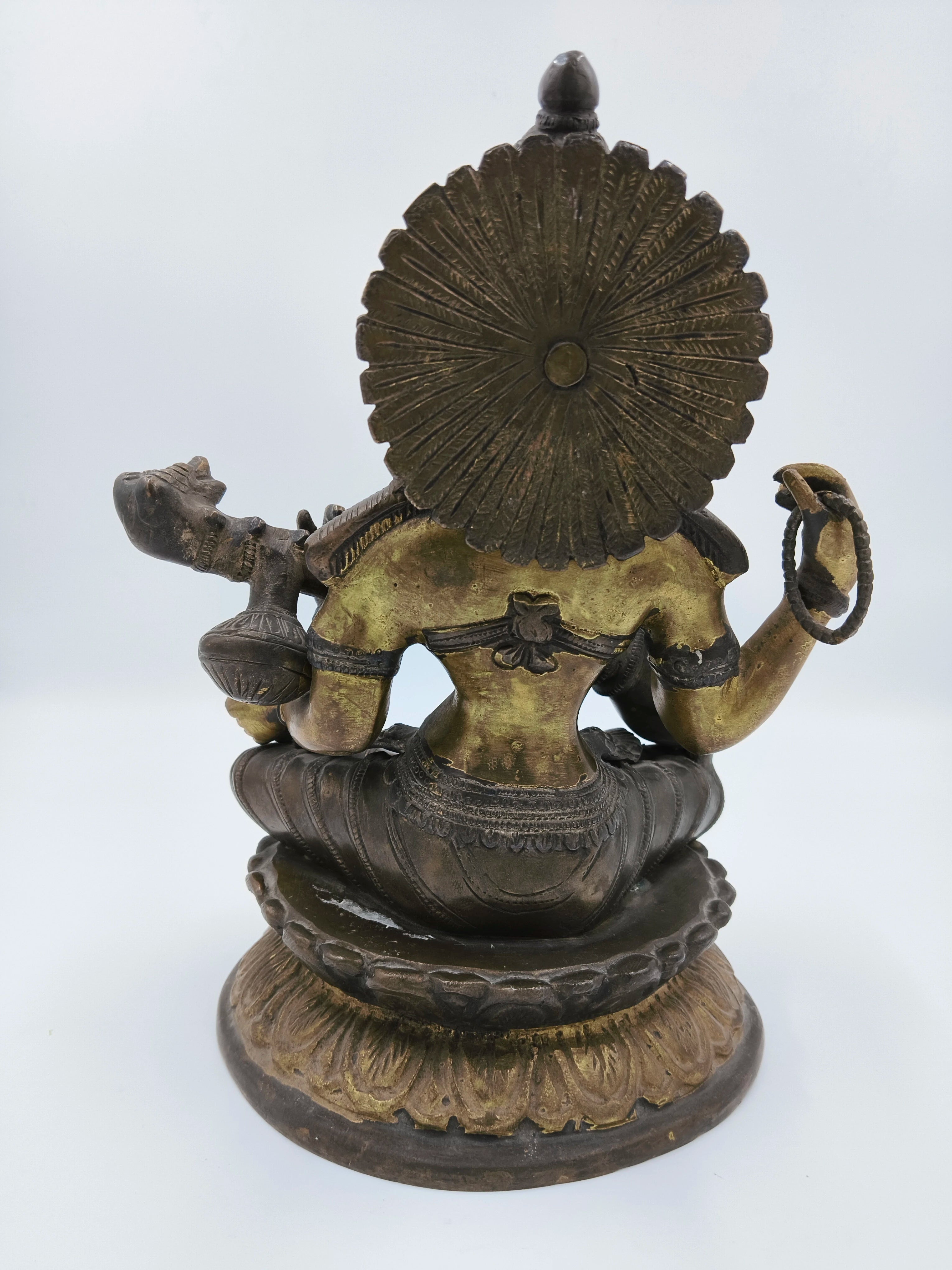 Back view of 9 inch brass Saraswathi statue seated on lotus pedestal