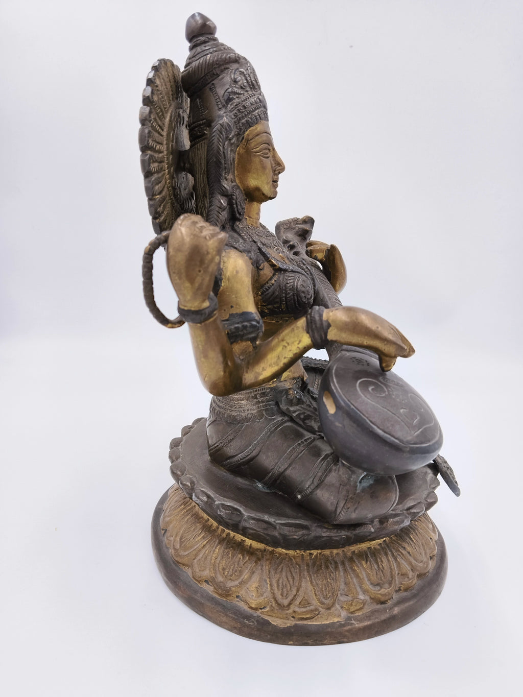Brass Saraswathi sculpture sitting on lotus base side view