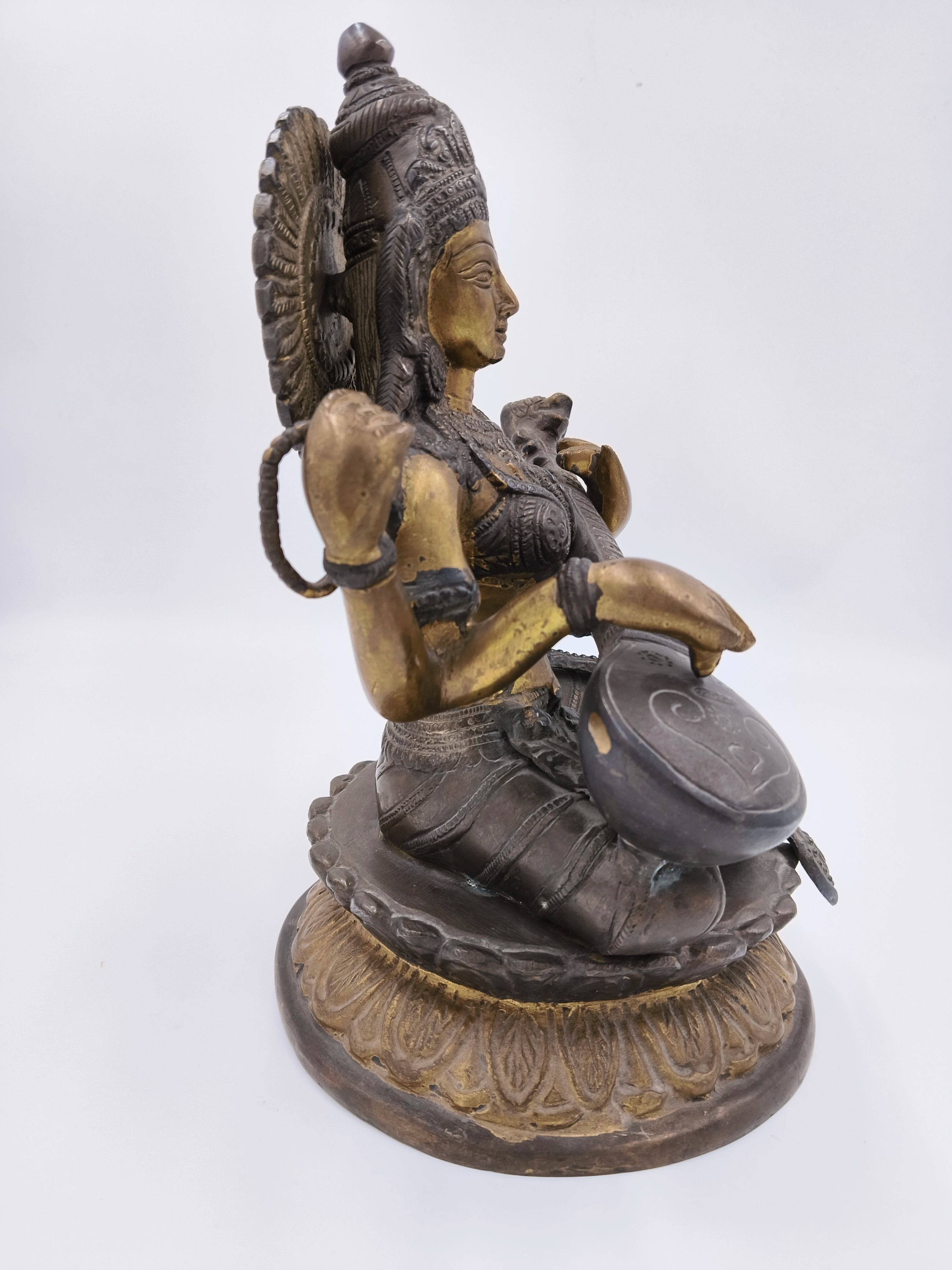Brass Saraswathi sculpture sitting on lotus base side view