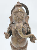 Close-up front view of a brass standing Ganesh statue with detailed engravings