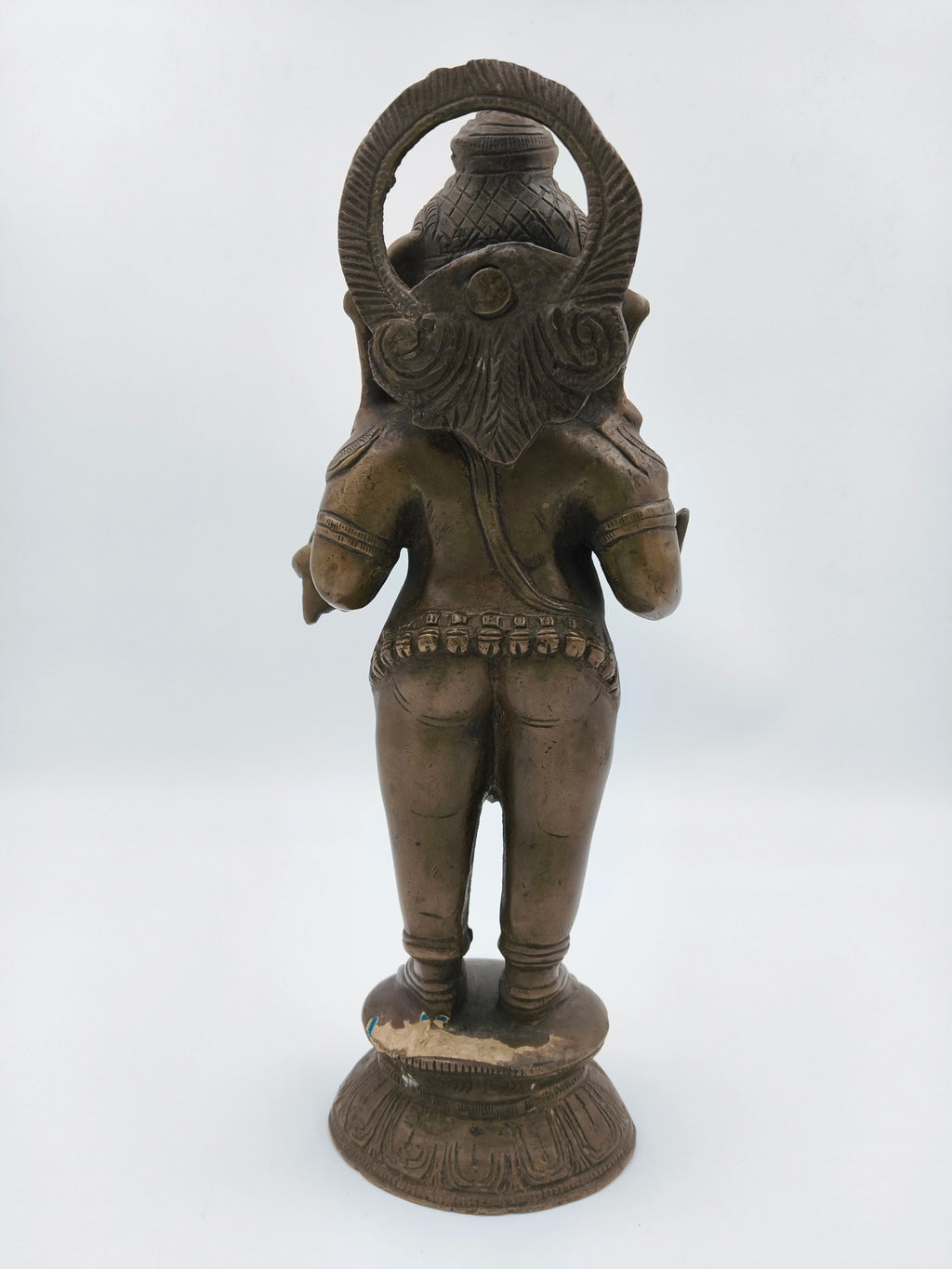Rear view of large brass standing Ganesh statue with ornate base