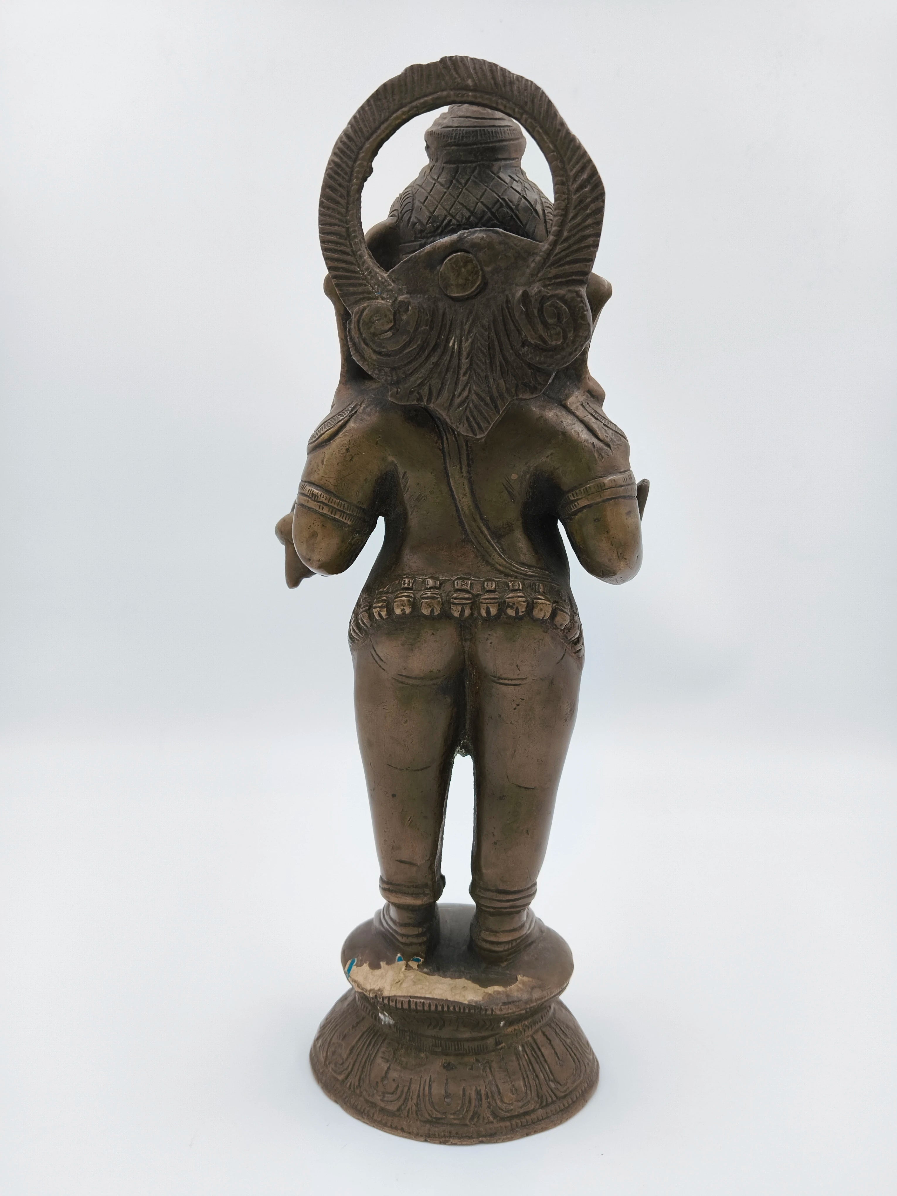 Rear view of large brass standing Ganesh statue with ornate base
