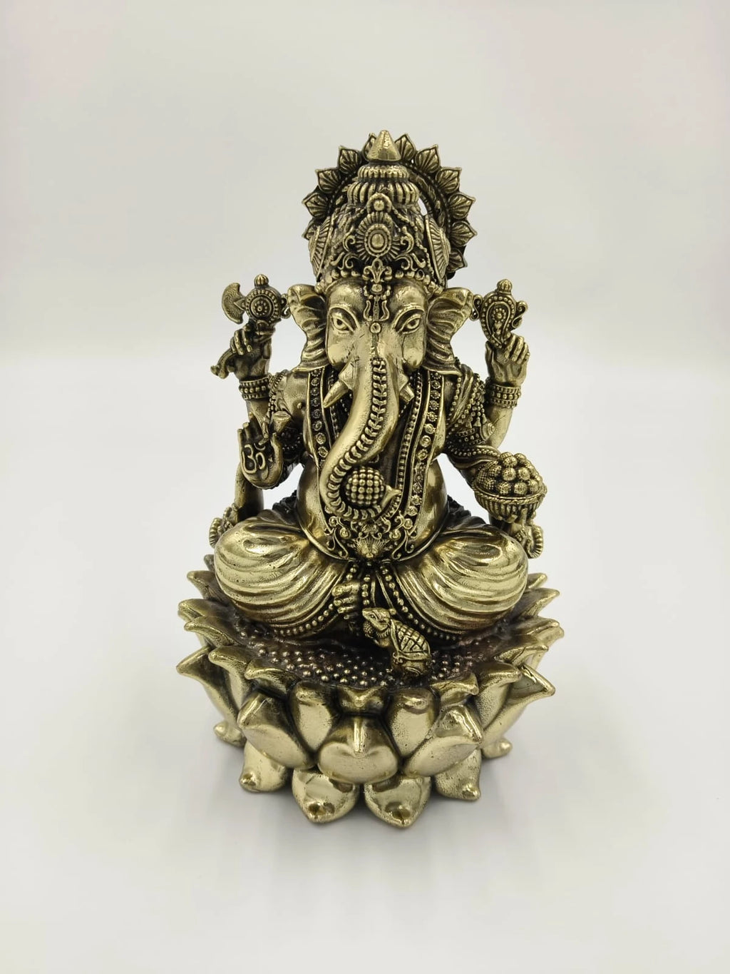 Brass statue of Padmasana Ganapati seated on a lotus pedestal front view