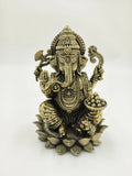 Medium brass sculpture of Ganesh sitting on a lotus with intricate details