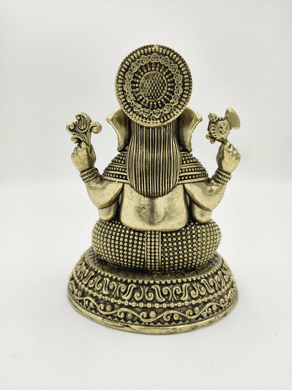 Back view of brass Padma Hasta Ganapati sculpture with intricate detailing