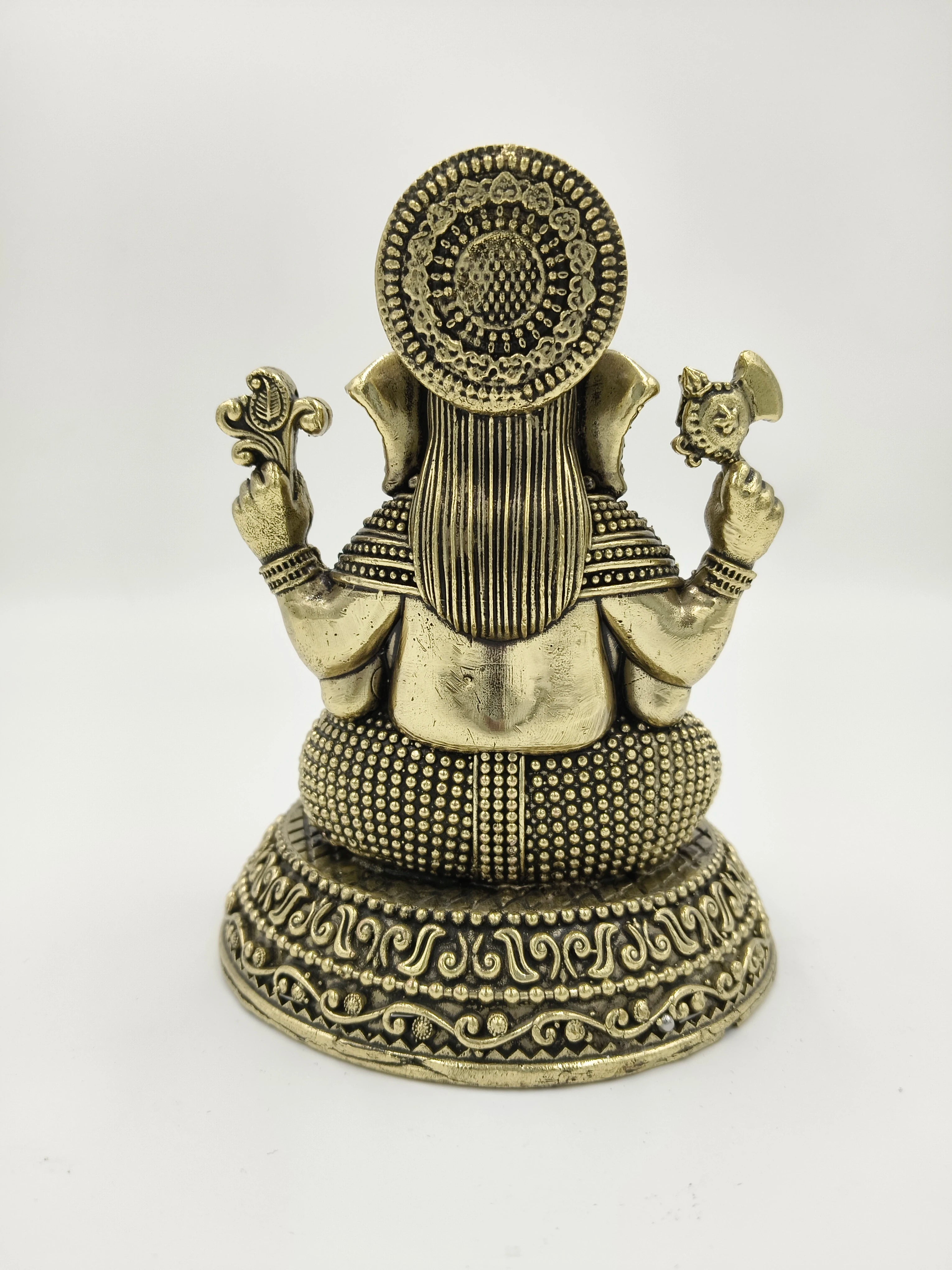 Back view of brass Padma Hasta Ganapati sculpture with intricate detailing