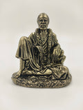 Mini brass sculpture of Shirdi Sai Baba seated with garlands