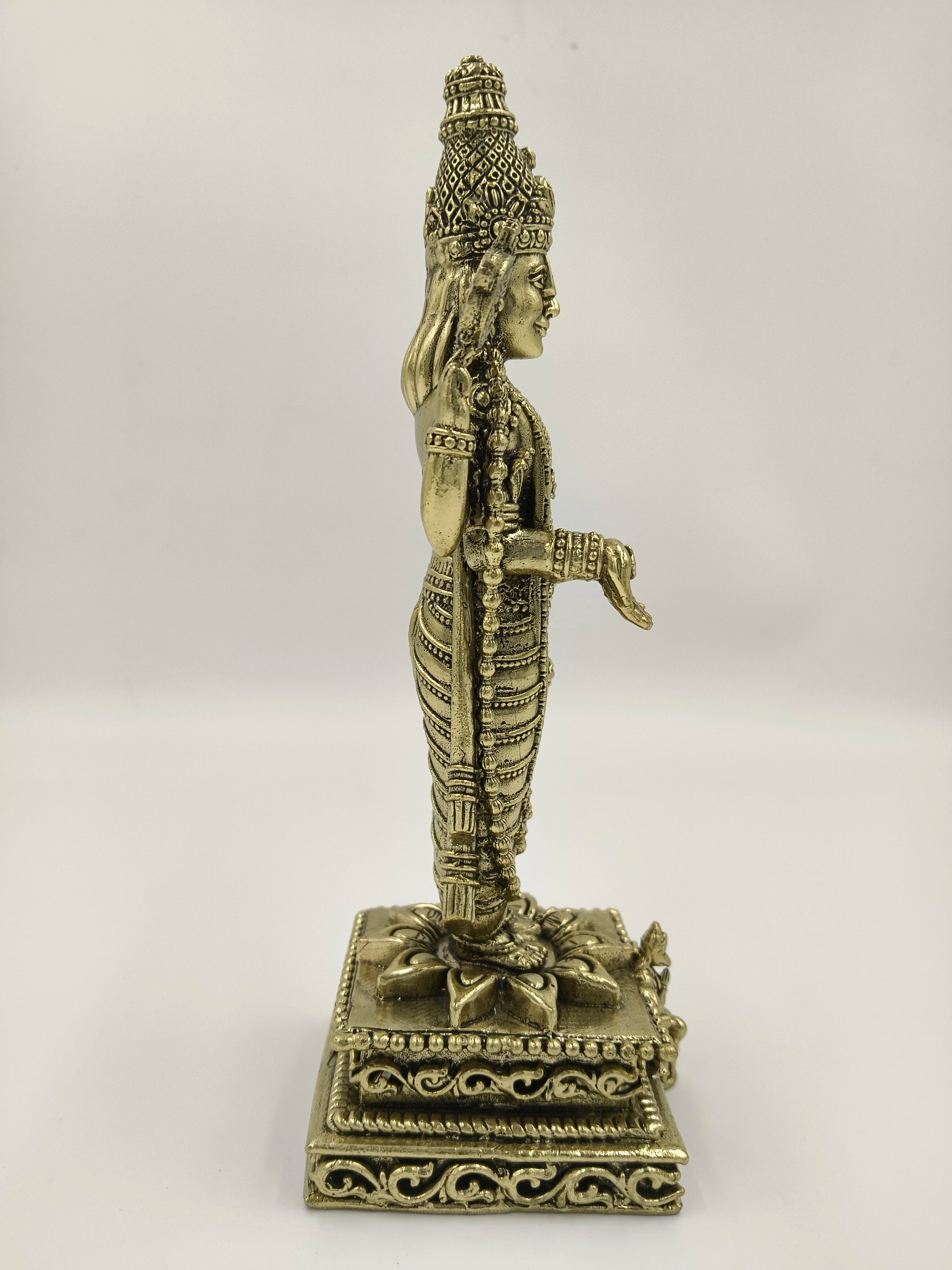 Side view of a large brass Balaji sculpture standing on an ornate pedestal