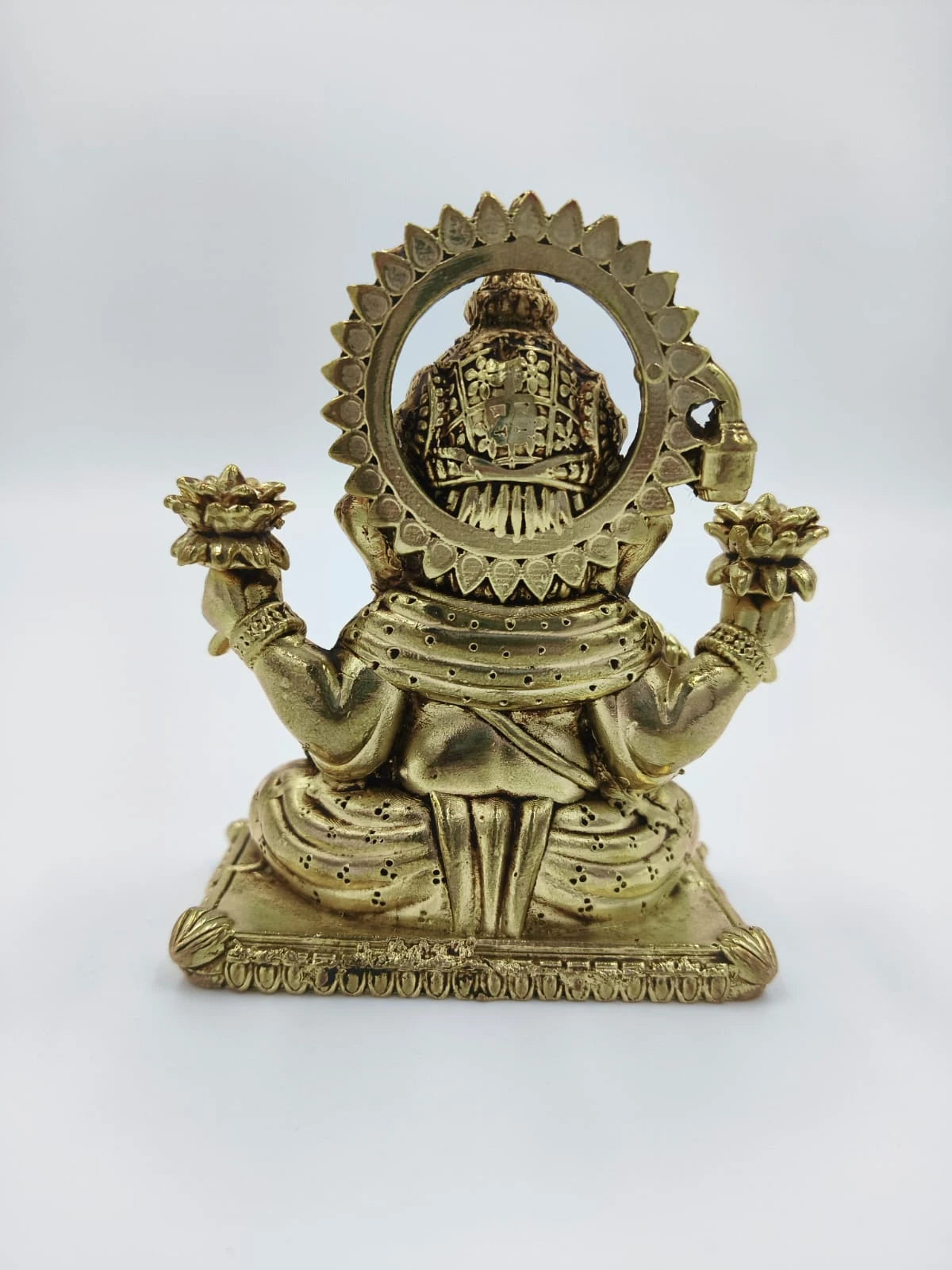 Rear view of brass Padma Hasta Ganapati sculpture with lotus flowers